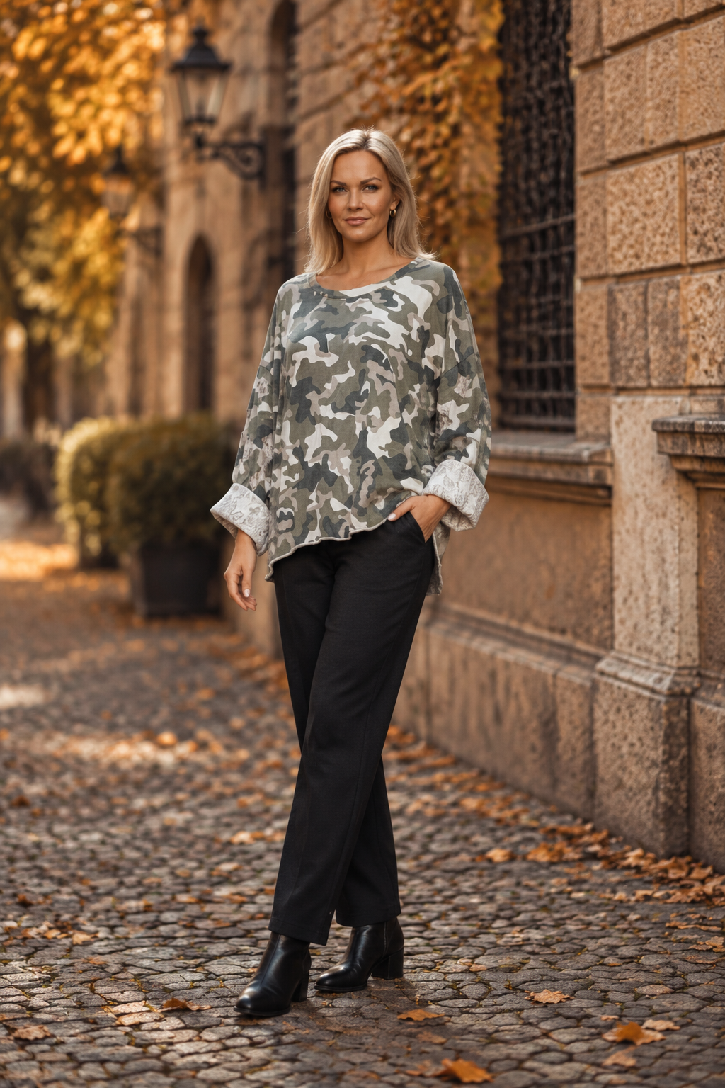 Tre-kvarts pose med svarta byxor och boots